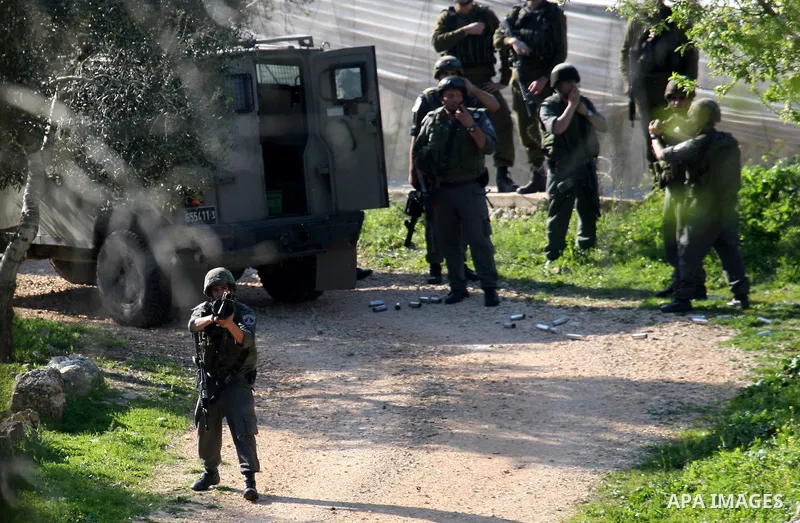 Israeli soldiers take position during clashes between Israeli settlers and Palestinian youths in the West Bank village of Yasuf south of Nablus, Friday, March 18, 2011. Photo by Wagdi Eshtayah