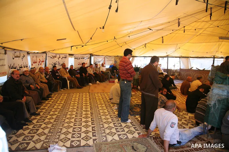 Palestinian demonstrators attend Friday prayers at the protest tent in Jerusalem's neighbourhood of silwan on March 18, 2011. Photo by Sliman Khader