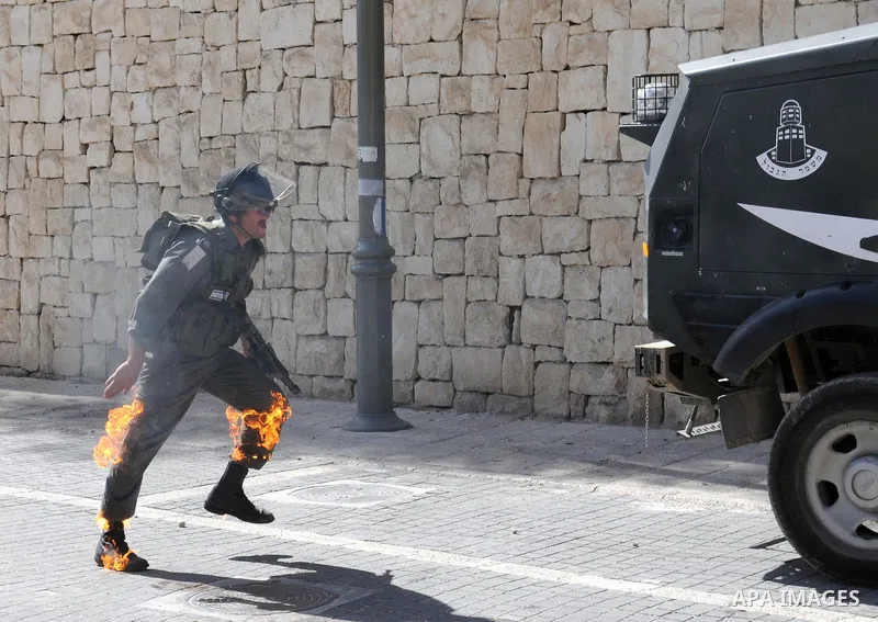 An Israeli border police tries to escape from a Molotov cocktail thrown by Palestinian youths, during clashes in the east Jerusalem neighborhood of Silwan, Friday, March 18, 2011. Photo by Sliman Khader