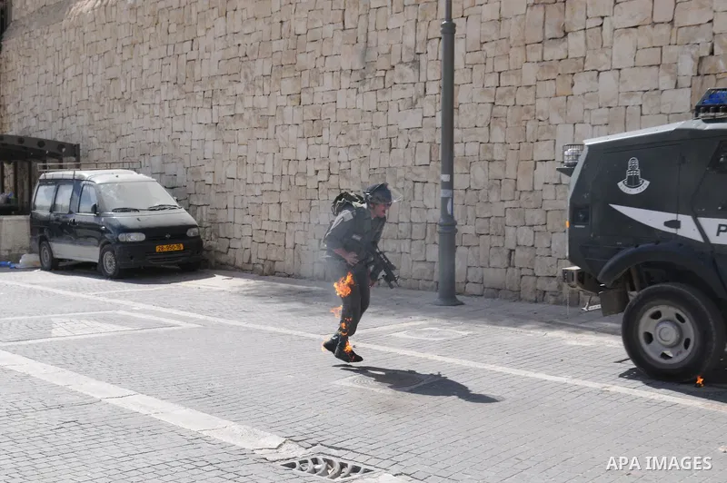 An Israeli border police tries to escape from a Molotov cocktail thrown by Palestinian youths, during clashes in the east Jerusalem neighborhood of Silwan, Friday, March 18, 2011. Photo by Sliman Khader