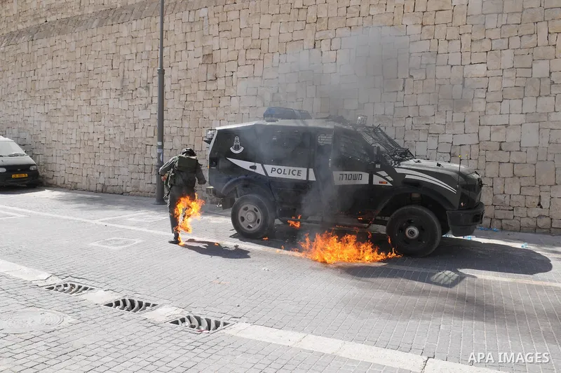 An Israeli border police tries to escape from a Molotov cocktail thrown by Palestinian youths, during clashes in the east Jerusalem neighborhood of Silwan, Friday, March 18, 2011. Photo by Sliman Khader