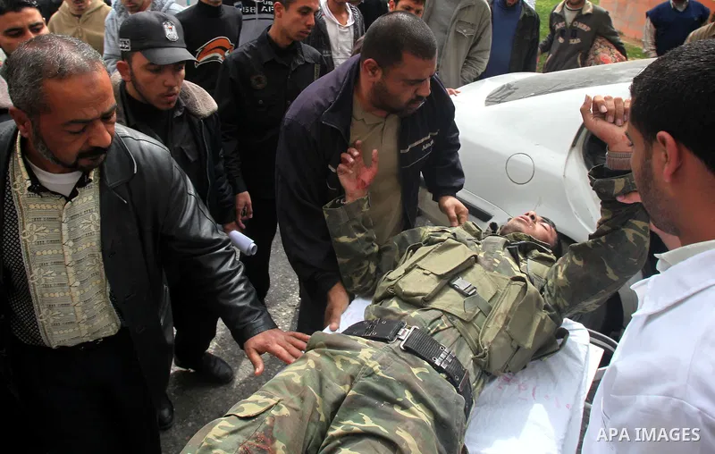 Palestinians carry a wounded member of the Hamas security forces after Israeli strikes on the Gaza Strip . Israeli strikes on the Gaza Strip wounded five Hamas security officers and a boy on Saturday after militants laun...
