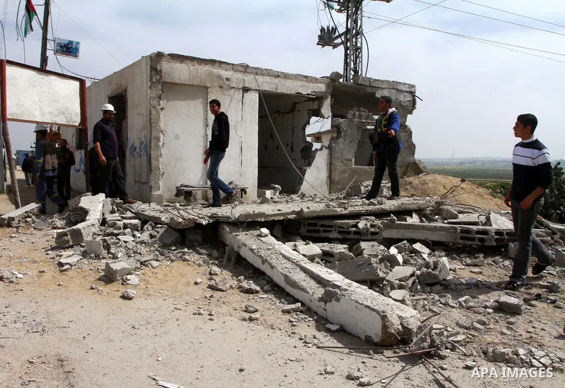 Palestinian looks at the damage after Israeli strikes on the Gaza Strip. Israeli strikes on the Gaza Strip wounded five Hamas security officers and a boy on Saturday after militants launched mortar bombs into Israel, lig...