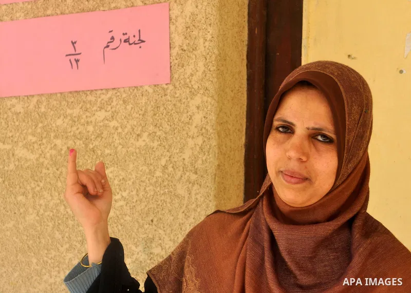 Egyptian show their inked fingers after voting for the referendum on constitutional amendments in Cairo, capital of Egypt. Egyptians started voting on Saturday morning to decide on constitutional amendments aimed at ensu...