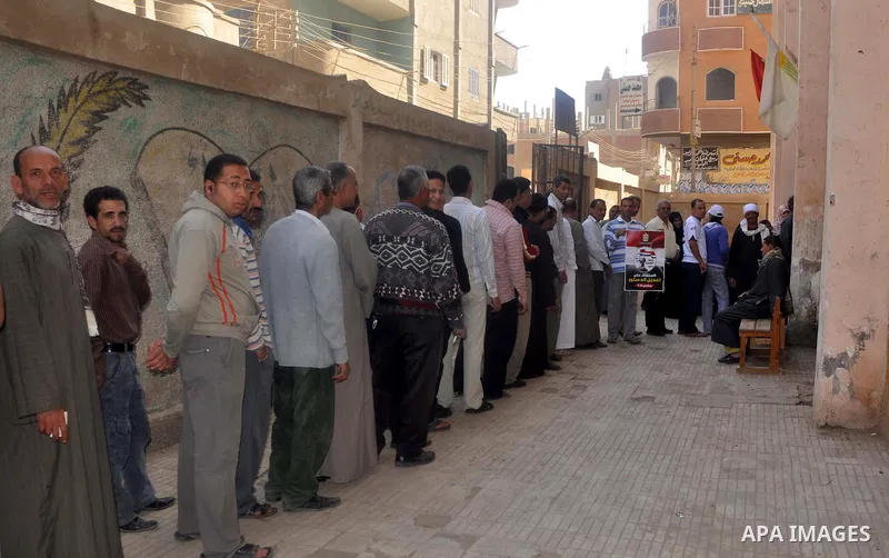 Egyptians queue to cast their vote during a national referendum, at a school in Cairo. Egyptians flocked to the polls on Saturday in a historic referendum on changes to the constitution. The amendments were proposed by a...