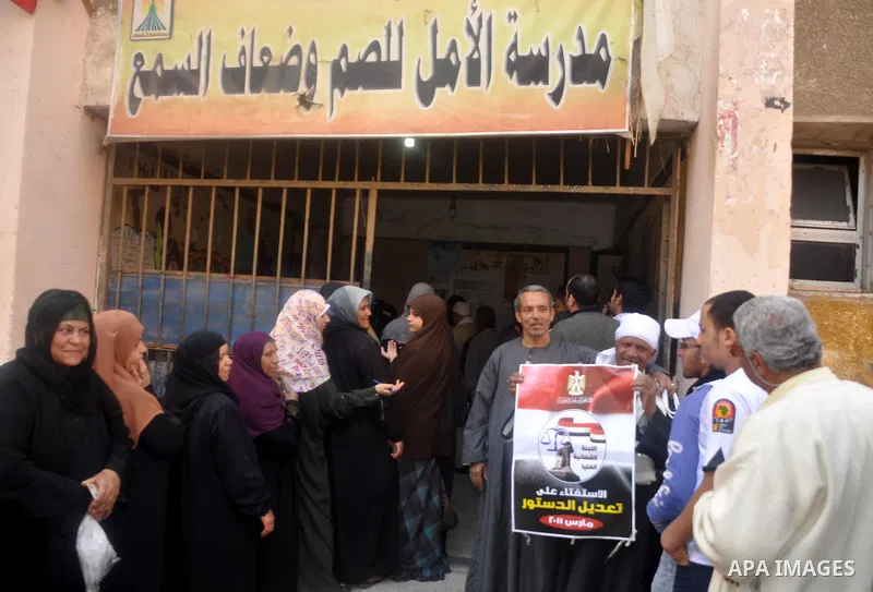 Egyptians queue to cast their vote during a national referendum, at a school in Cairo. Egyptians flocked to the polls on Saturday in a historic referendum on changes to the constitution. The amendments were proposed by a...