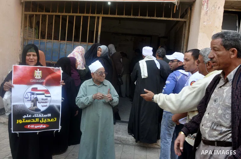 Egyptians queue to cast their vote during a national referendum, at a school in Cairo. Egyptians flocked to the polls on Saturday in a historic referendum on changes to the constitution. The amendments were proposed by a...