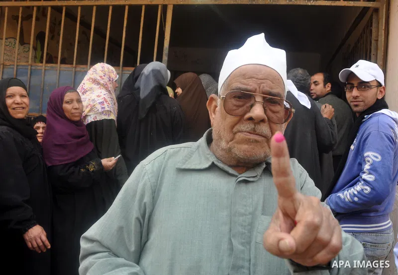 Egyptian show their inked fingers after voting for the referendum on constitutional amendments in Cairo, capital of Egypt. Egyptians started voting on Saturday morning to decide on constitutional amendments aimed at ensu...