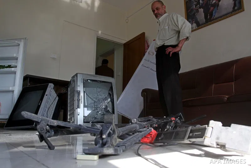 Palestinian journalists inspect the damages at Reuters office after Palestinian security forces raid the office in Gaza City on March 19,2011. Photo by Mohammed Asad