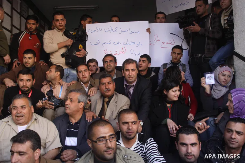 Palestinian journalists take part in a protest against the Palestinian security forces after they raid on the Reuters office in Gaza City on March 19,2011. Photo by Mohammed Asad