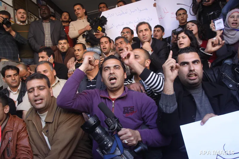 Palestinian journalists take part in a protest against the Palestinian security forces after they raid on the Reuters office in Gaza City on March 19,2011. Photo by Mohammed Asad