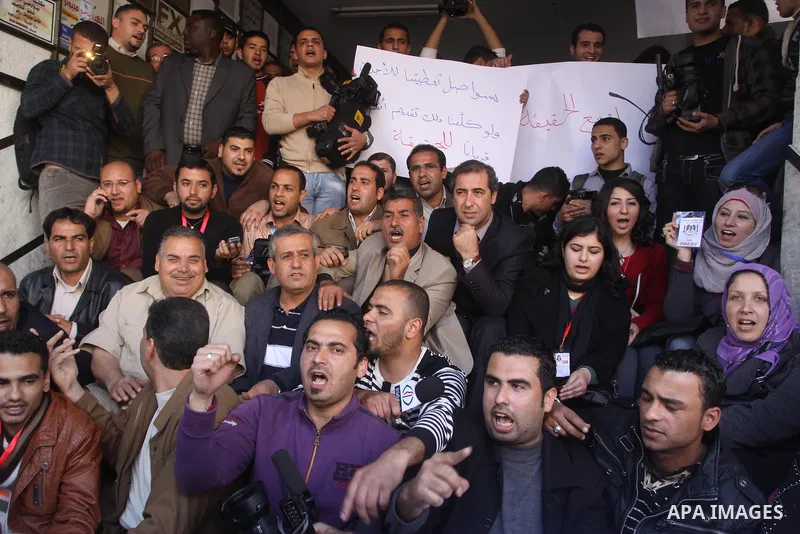 Palestinian journalists take part in a protest against the Palestinian security forces after they raid on the Reuters office in Gaza City on March 19,2011. Photo by Mohammed Asad