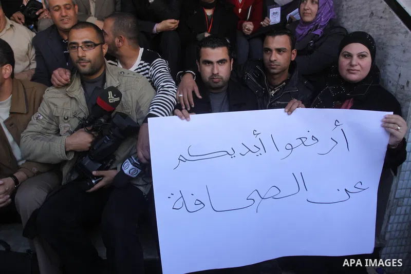 Palestinian journalists take part in a protest against the Palestinian security forces after they raid on the Reuters office in Gaza City on March 19,2011. Photo by Mohammed Asad