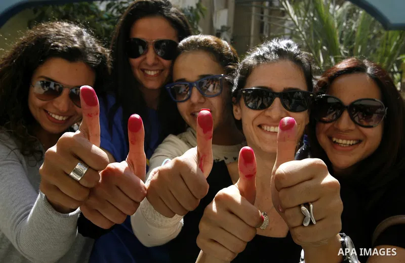 Egyptians show their inked fingers after voting for the referendum on constitutional amendments in Cairo, capital of Egypt. Egyptians started voting on Saturday morning to decide on constitutional amendments aimed at ens...