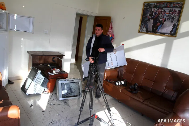 Palestinian journalists inspect the damages at Reuters office after Palestinian security forces raid the office in Gaza City on March 19,2011. Photo by Ashraf Amra