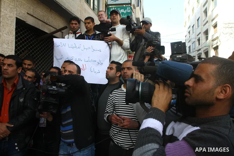 Palestinian journalists take part in a protest against the Palestinian security forces after they raid on the Reuters office in Gaza City on March 19,2011. Photo by Ashraf Amra