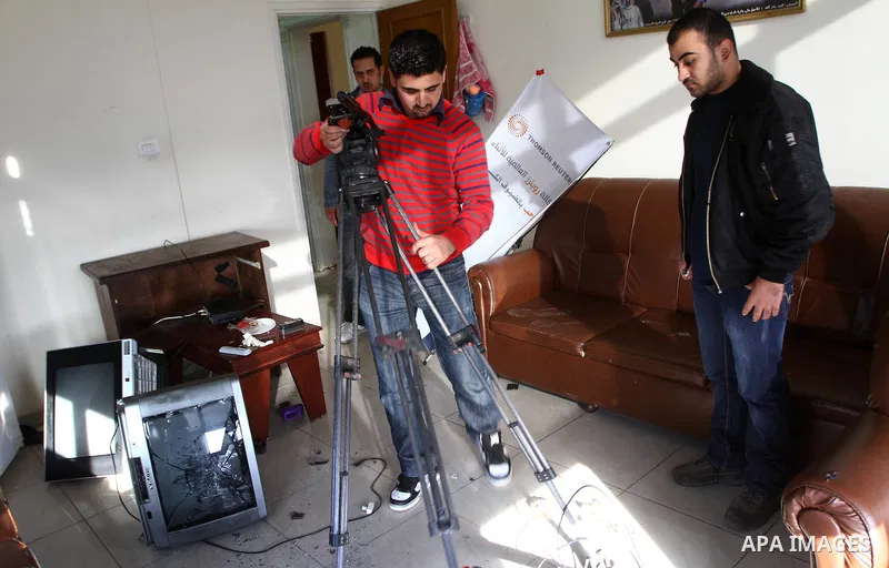 Palestinian journalists inspect the damages at Reuters office after Palestinian security forces raid the office in Gaza City on March 19,2011. Photo by Ashraf Amra