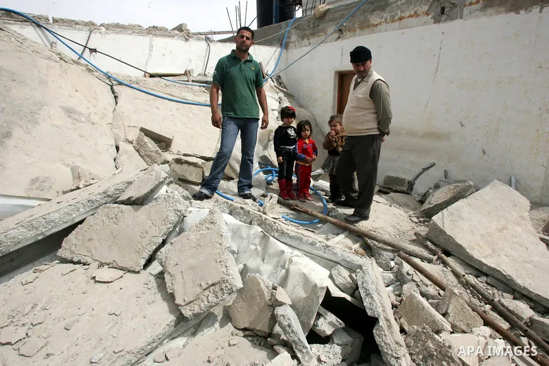 Palestinians stand on the rubble of their house after it was demolished by Israeli army in the Arab Jerusalem neighborhood of Sour Baher on March 19, 2011. Photo by Mahfouz Abu Turk