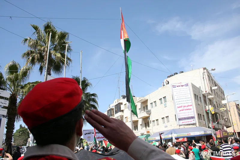 Palestinian scouts carry the national flag as they parade in Manara Square in down town Ramallah on March 19, 2011, calling for unity amongst the Palestinian people. Photo by Issam Rimawi