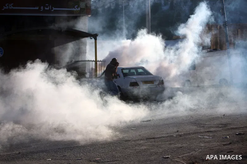 Israeli Border Police fire tear gas towards Palestinian stone throwers during a clash in the Shuafat Refugee Camp, north of Jerusalem, in the West Bank, 19 March 2011. Palestinians clashed with Israeli forces in several...