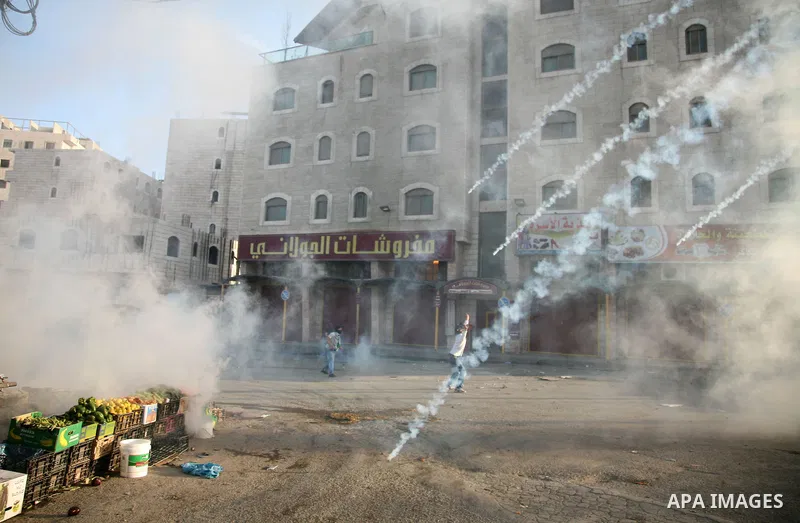 Israeli Border Police fire tear gas towards Palestinian stone throwers during a clash in the Shuafat Refugee Camp, north of Jerusalem, in the West Bank, 19 March 2011. Palestinians clashed with Israeli forces in several...