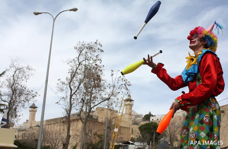 Israelis parade during their celebration of the Jewish holiday of Purim in the divided West Bank city of Hebron, on 20 March 2011. The joyful Jewish holiday of Purim celebrates the Jews' salvation from genocide in ancien...