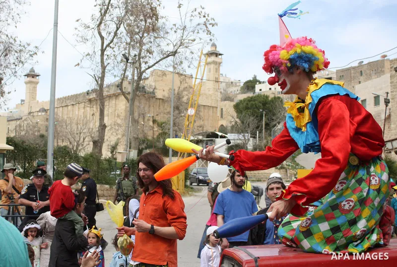 Israelis parade during their celebration of the Jewish holiday of Purim in the divided West Bank city of Hebron, on 20 March 2011. The joyful Jewish holiday of Purim celebrates the Jews' salvation from genocide in ancien...
