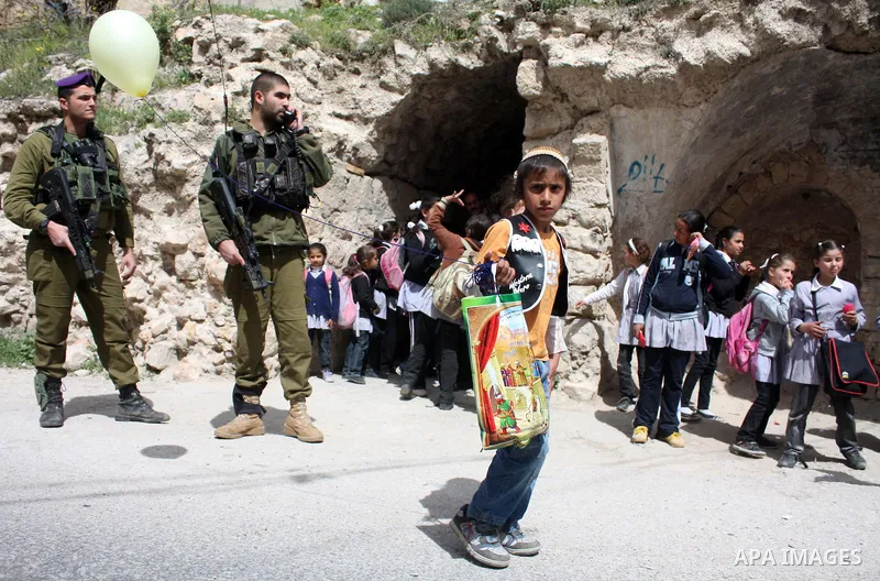Israelis parade during their celebration of the Jewish holiday of Purim in the divided West Bank city of Hebron, on 20 March 2011. The joyful Jewish holiday of Purim celebrates the Jews' salvation from genocide in ancien...