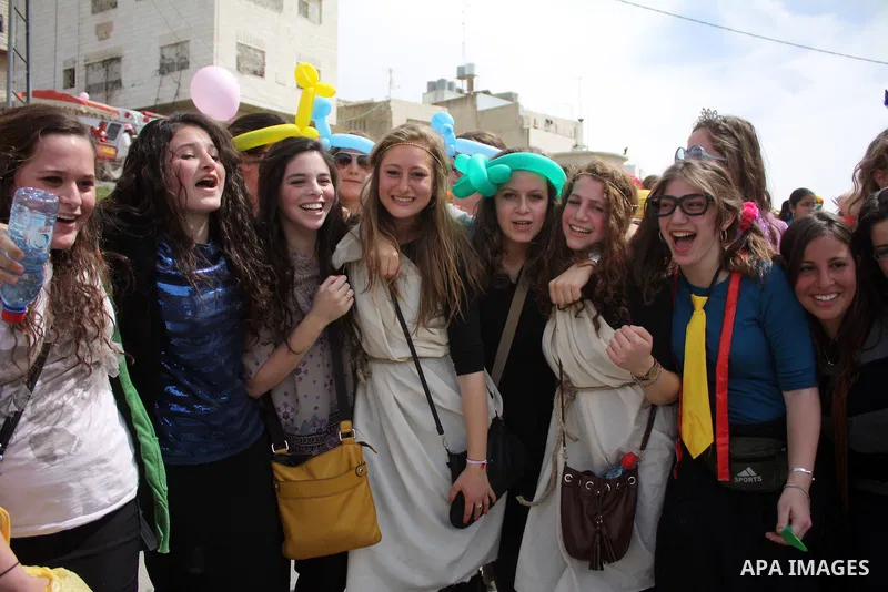 Israelis parade during their celebration of the Jewish holiday of Purim in the divided West Bank city of Hebron, on 20 March 2011. The joyful Jewish holiday of Purim celebrates the Jews' salvation from genocide in ancien...