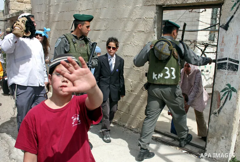 Israelis parade during their celebration of the Jewish holiday of Purim in the divided West Bank city of Hebron, on 20 March 2011. The joyful Jewish holiday of Purim celebrates the Jews' salvation from genocide in ancien...