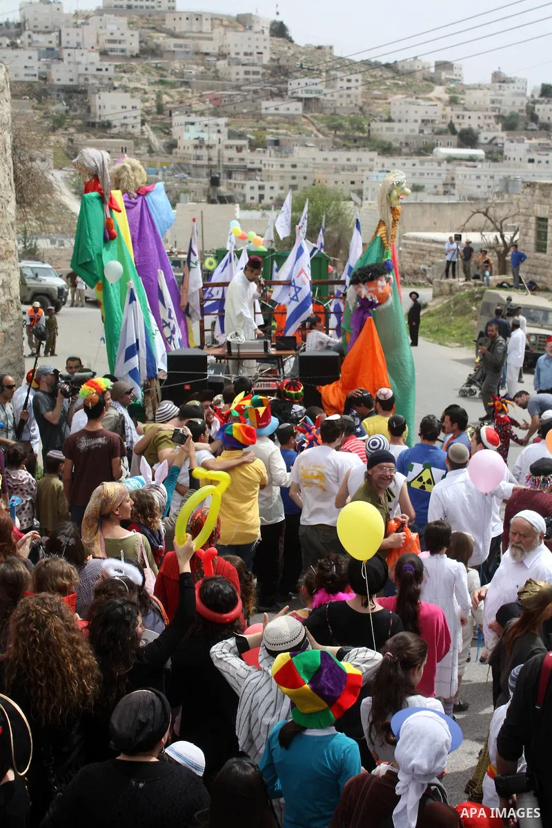 Israelis parade during their celebration of the Jewish holiday of Purim in the divided West Bank city of Hebron, on 20 March 2011. The joyful Jewish holiday of Purim celebrates the Jews' salvation from genocide in ancien...