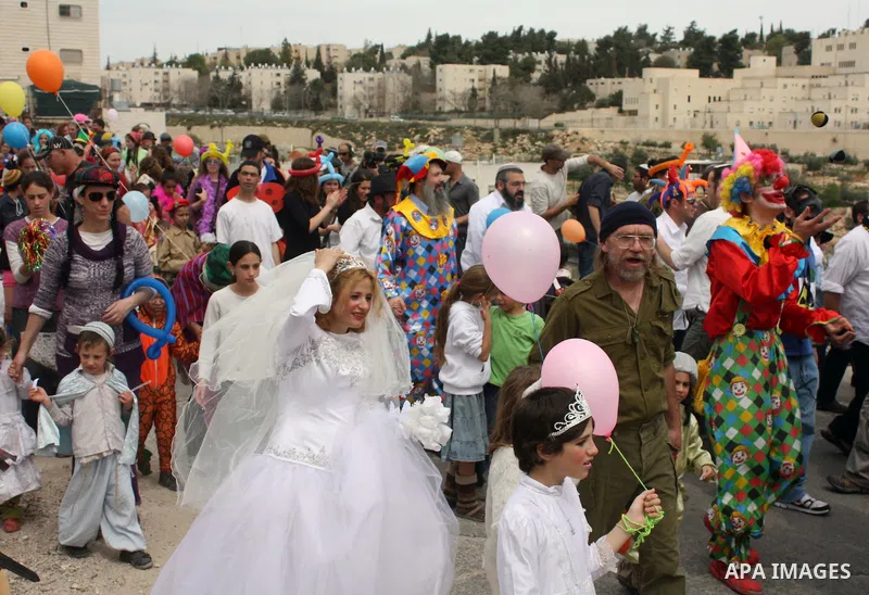 Israelis parade during their celebration of the Jewish holiday of Purim in the divided West Bank city of Hebron, on 20 March 2011. The joyful Jewish holiday of Purim celebrates the Jews' salvation from genocide in ancien...