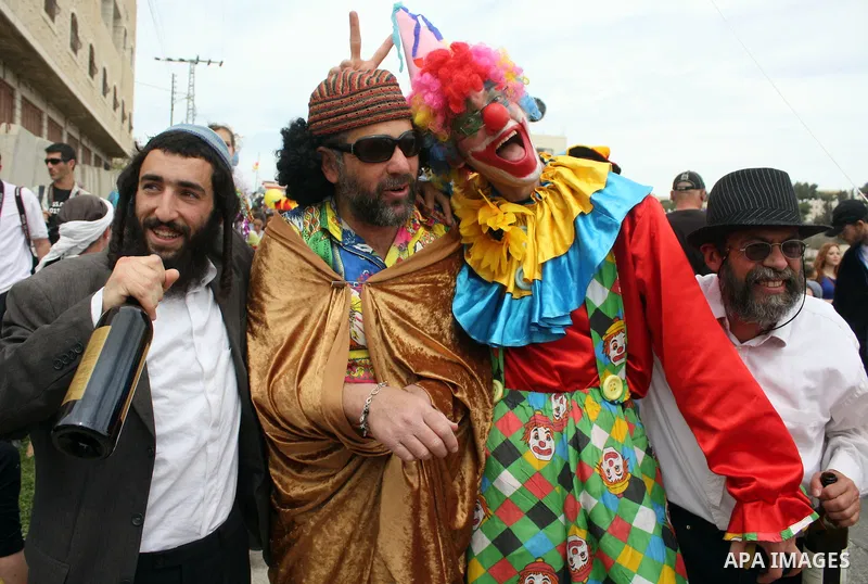 Israelis parade during their celebration of the Jewish holiday of Purim in the divided West Bank city of Hebron, on 20 March 2011. The joyful Jewish holiday of Purim celebrates the Jews' salvation from genocide in ancien...