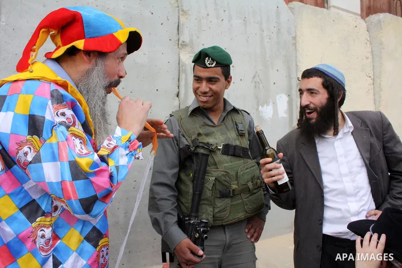 Israelis parade during their celebration of the Jewish holiday of Purim in the divided West Bank city of Hebron, on 20 March 2011. The joyful Jewish holiday of Purim celebrates the Jews' salvation from genocide in ancien...