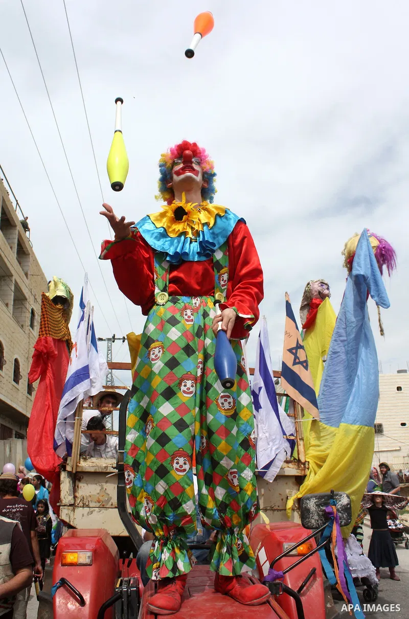 Israelis parade during their celebration of the Jewish holiday of Purim in the divided West Bank city of Hebron, on 20 March 2011. The joyful Jewish holiday of Purim celebrates the Jews' salvation from genocide in ancien...