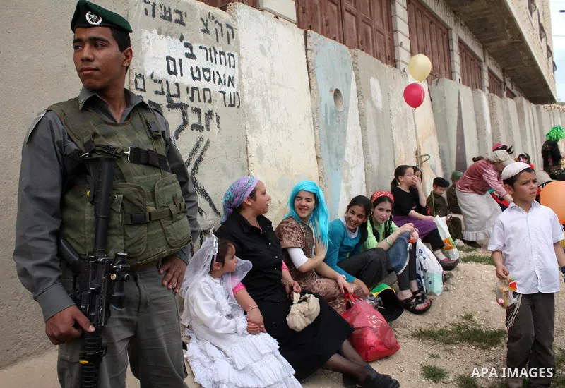 Israelis parade during their celebration of the Jewish holiday of Purim in the divided West Bank city of Hebron, on 20 March 2011. The joyful Jewish holiday of Purim celebrates the Jews' salvation from genocide in ancien...