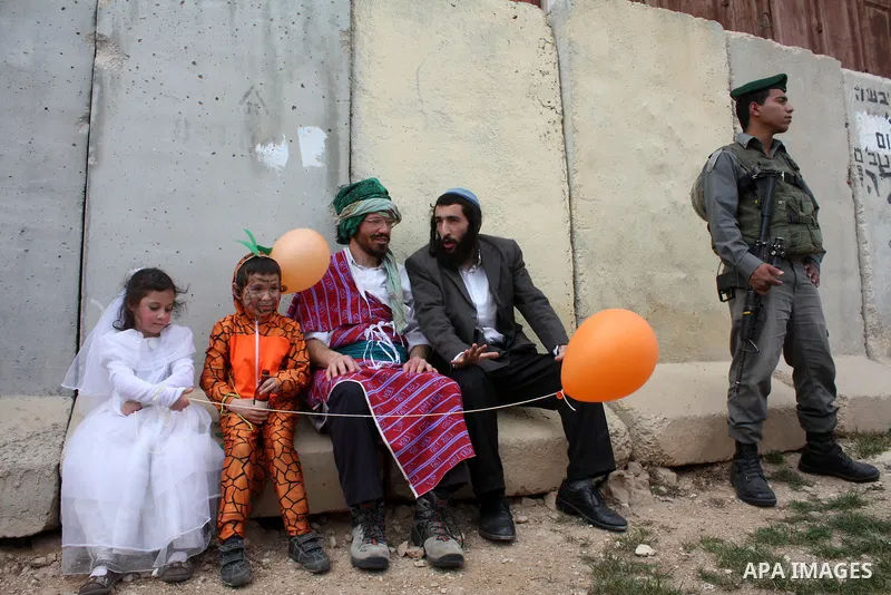 Israelis parade during their celebration of the Jewish holiday of Purim in the divided West Bank city of Hebron, on 20 March 2011. The joyful Jewish holiday of Purim celebrates the Jews' salvation from genocide in ancien...