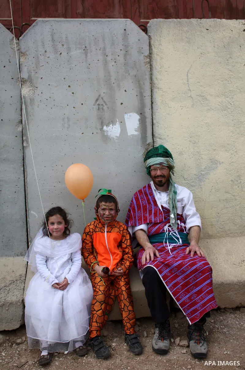 Israelis parade during their celebration of the Jewish holiday of Purim in the divided West Bank city of Hebron, on 20 March 2011. The joyful Jewish holiday of Purim celebrates the Jews' salvation from genocide in ancien...