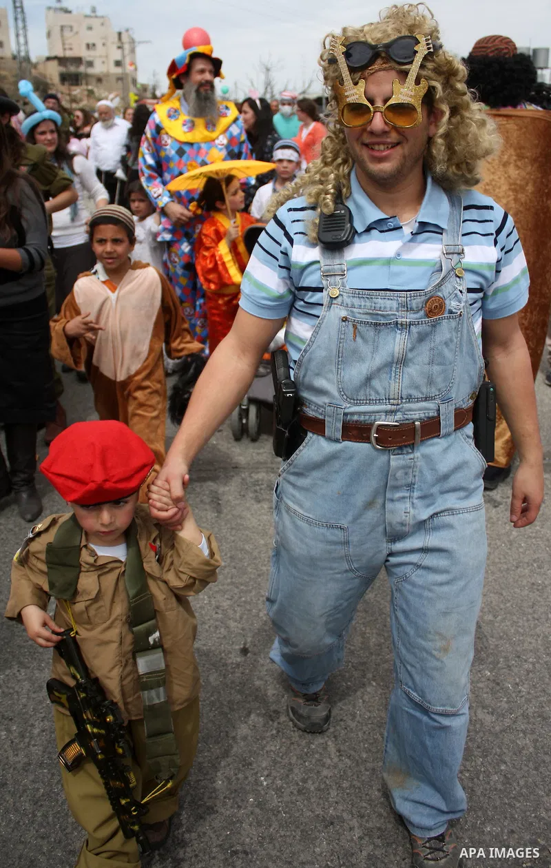 Israelis parade during their celebration of the Jewish holiday of Purim in the divided West Bank city of Hebron, on 20 March 2011. The joyful Jewish holiday of Purim celebrates the Jews' salvation from genocide in ancien...