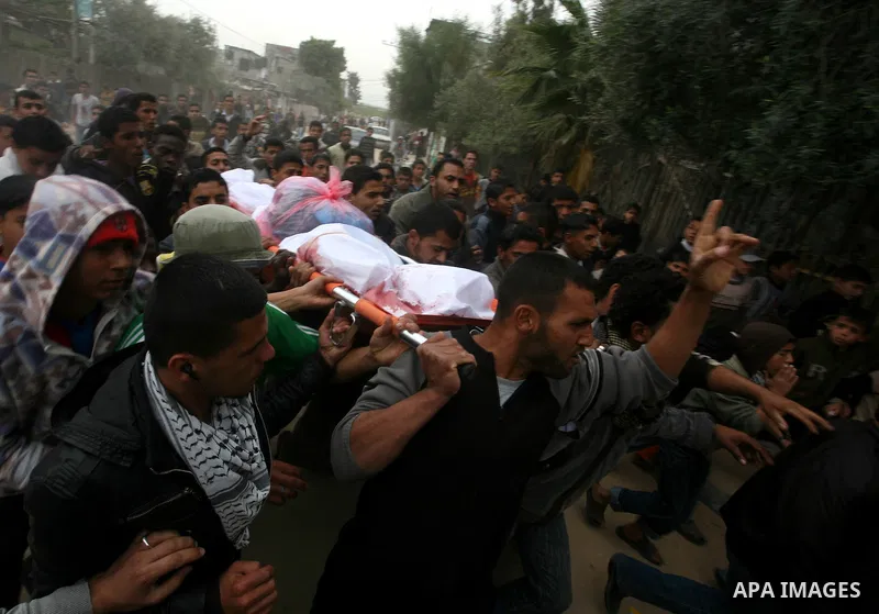 Palestinians, relatives of Emad Faragallah, mourn during his funeral in Nusairat refugee camp in the central Gaza Strip March 20, 2011. Two Palestinians, including Faragallah were killed by Israeli gunfire on Saturday ne...