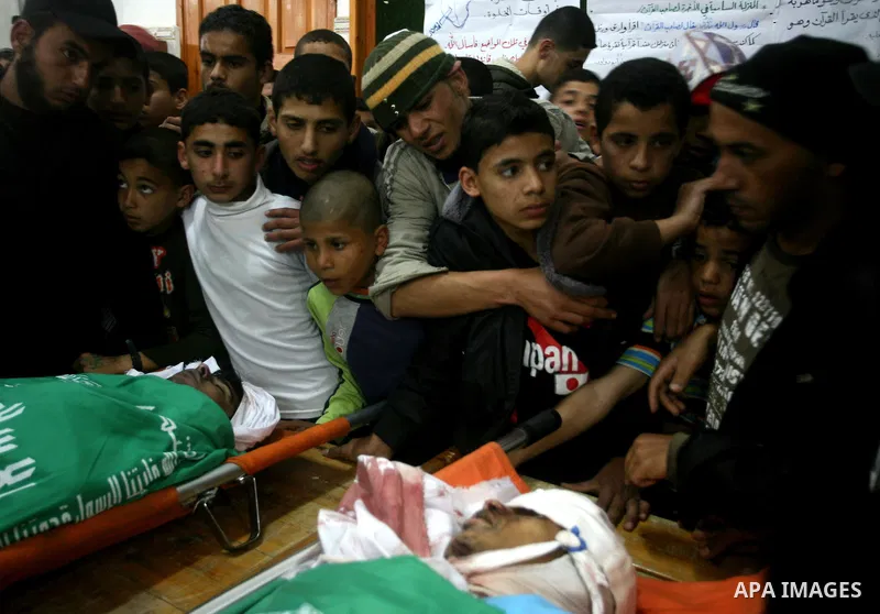 Palestinians, relatives of Emad Faragallah, mourn during his funeral in Nusairat refugee camp in the central Gaza Strip March 20, 2011. Two Palestinians, including Faragallah were killed by Israeli gunfire on Saturday ne...