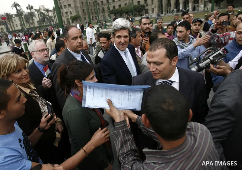 US senator John Kerry greets Egyptians as he visits Tahrir Square, the focal point of Egyptian uprising, in Cairo, Egypt, Sunday, March 20, 2011. Kerry hold talks with Egypt's military rulers, the Supreme Council of the...