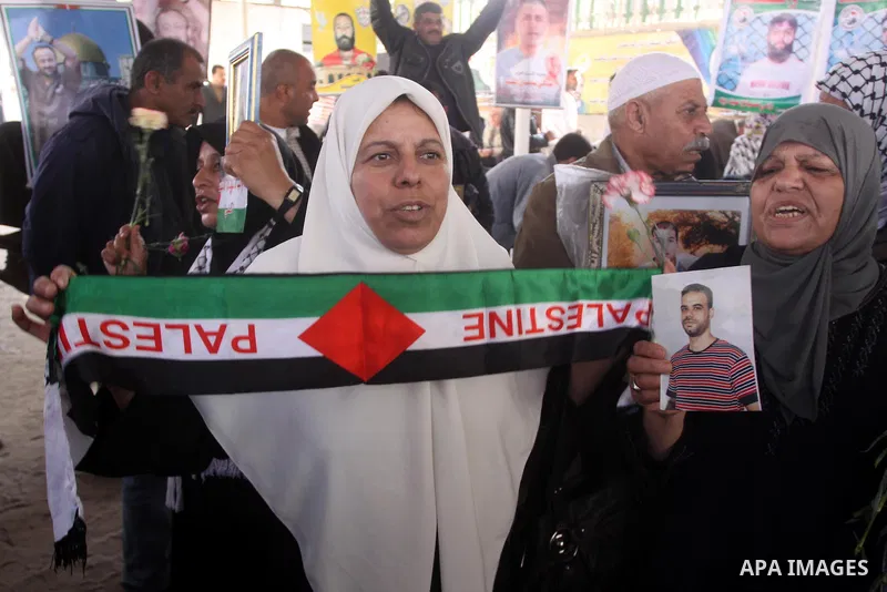 Palestinian women hold pictures of jailed relatives during a protest calling for the release of Palestinian prisoners from Israeli jails. Gaza city on March 21,2011 . Photo by Mohammed Asad