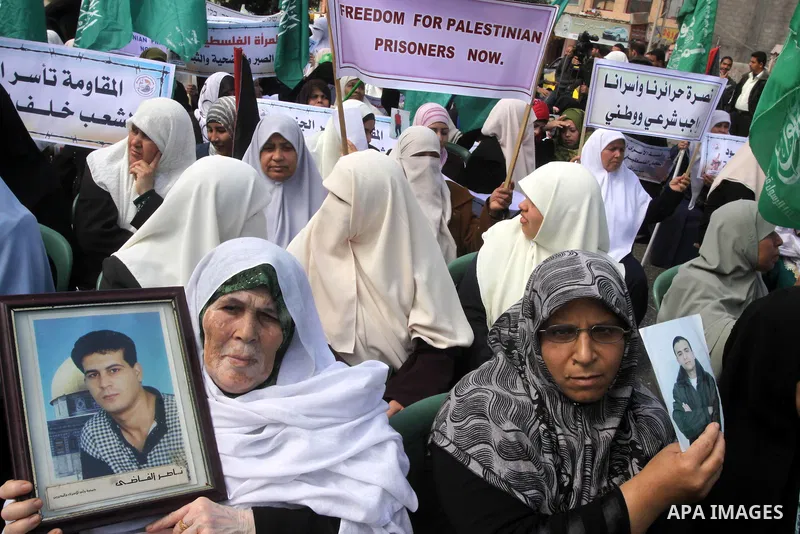 Palestinian women hold pictures of jailed relatives during a protest calling for the release of Palestinian prisoners from Israeli jails. Gaza city on March 21,2011 . Photo by Mohammed Asad