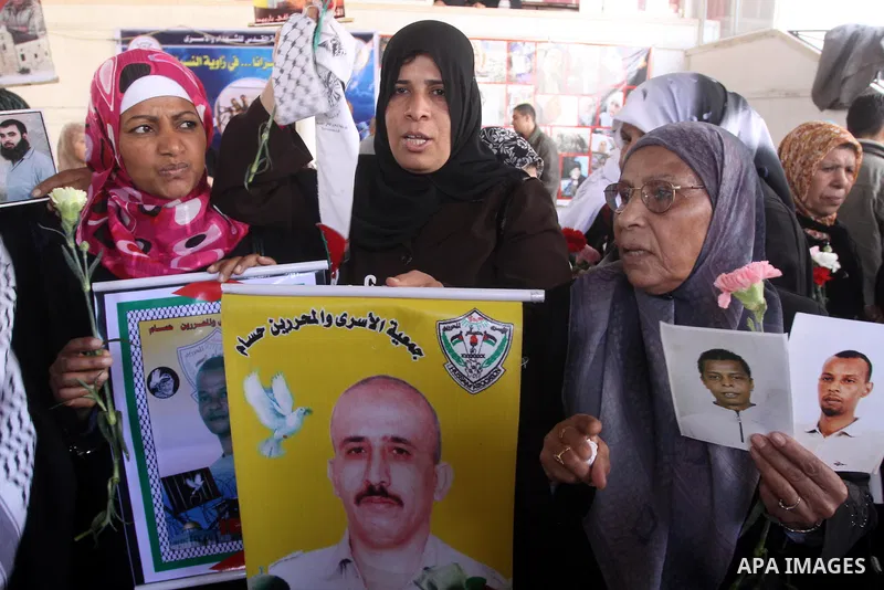 Palestinian women hold pictures of jailed relatives during a protest calling for the release of Palestinian prisoners from Israeli jails. Gaza city on March 21,2011 . Photo by Mohammed Asad