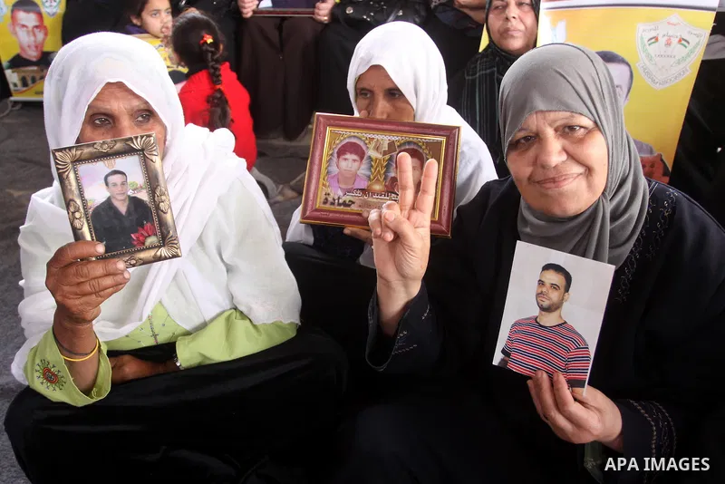 Palestinian women hold pictures of jailed relatives during a protest calling for the release of Palestinian prisoners from Israeli jails. Gaza city on March 21,2011 . Photo by Mohammed Asad