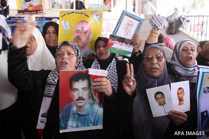 Palestinian women hold pictures of jailed relatives during a protest calling for the release of Palestinian prisoners from Israeli jails. Gaza city on March 21,2011 . Photo by Mohammed Asad