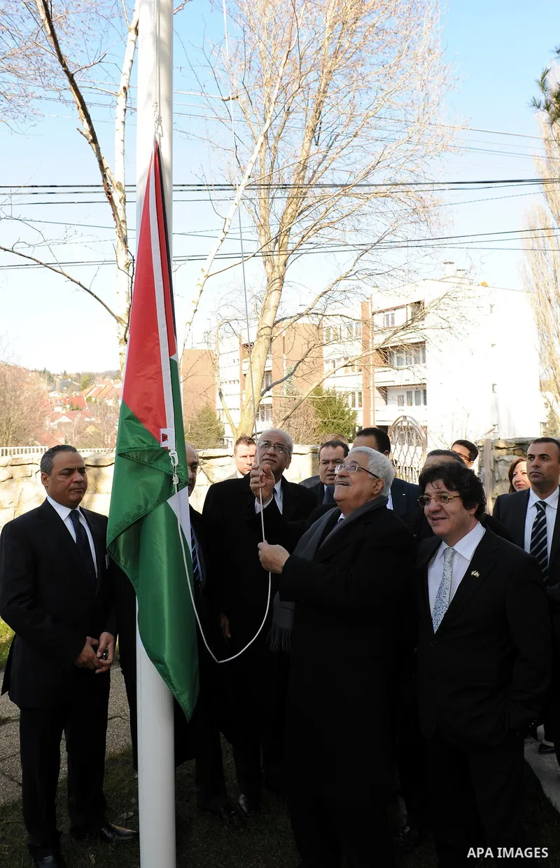 Palestinian President Mahmoud Abbas raises the Palestinian flag in the courtyard of the building of the Palestinian embassy in Budapest on March 21, 20011. The Palestinian National Council was saddened by the bloodshed i...