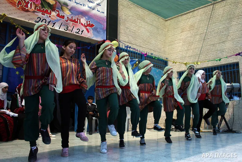 Palestinian women attend a celebration at Al-Walajah school on the occasion of Mother Day in Walajah village near the West Bank city of Bethlehem on March 21, 2011. Photo by Issam Rimawi