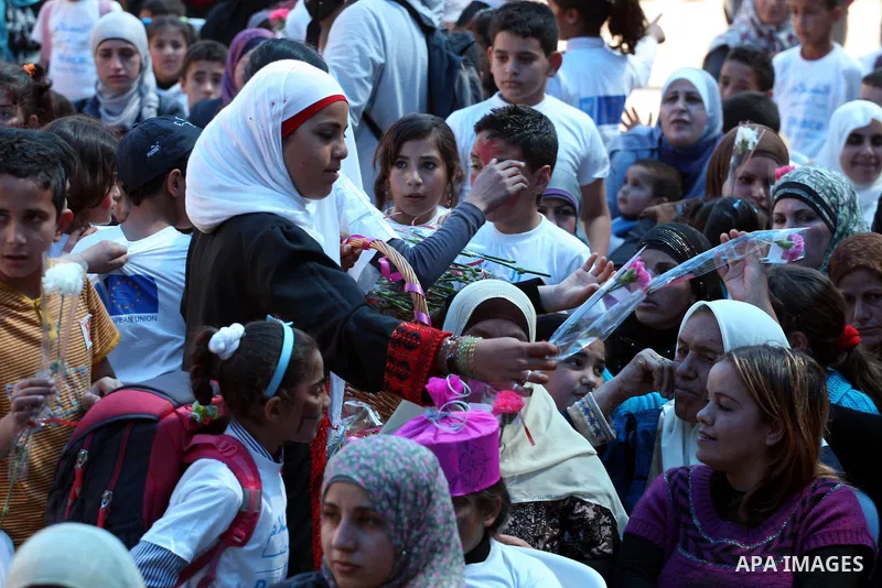Palestinian women attend a celebration at Al-Walajah school on the occasion of Mother Day in Walajah village near the West Bank city of Bethlehem on March 21, 2011. Photo by Issam Rimawi